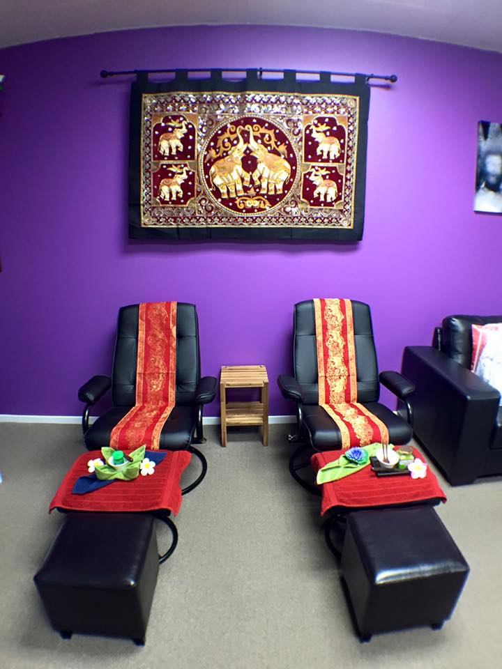 Two comfortable chairs and two stools setup ready for foot massage inside Sawaddee